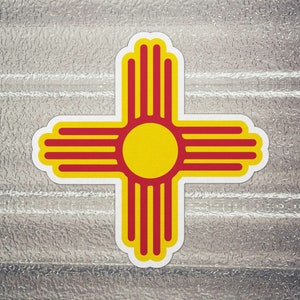 May include: A yellow sun symbol with red rays, known as the Zia symbol, is a common symbol of the state of New Mexico.