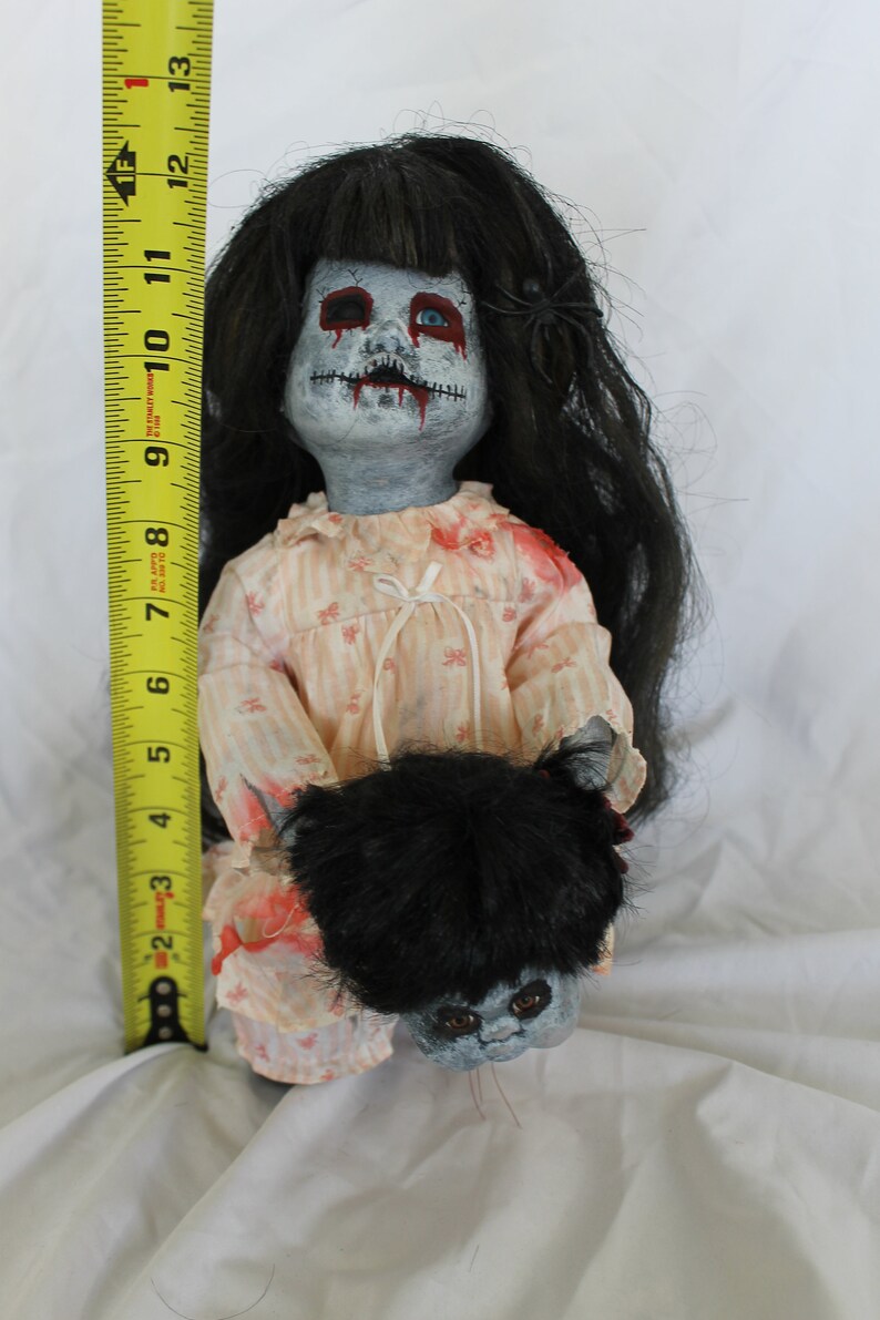 creepy girl with black hair and doll