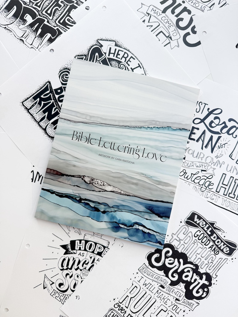 Pode incluir: Um livro intitulado "Bible Lettering Love" com um design abstrato em aquarela em tons de azul, cinza e marrom. O livro &eacute; cercado por v&aacute;rias p&aacute;ginas brancas com cita&ccedil;&otilde;es e frases inspiradoras manuscritas em preto.