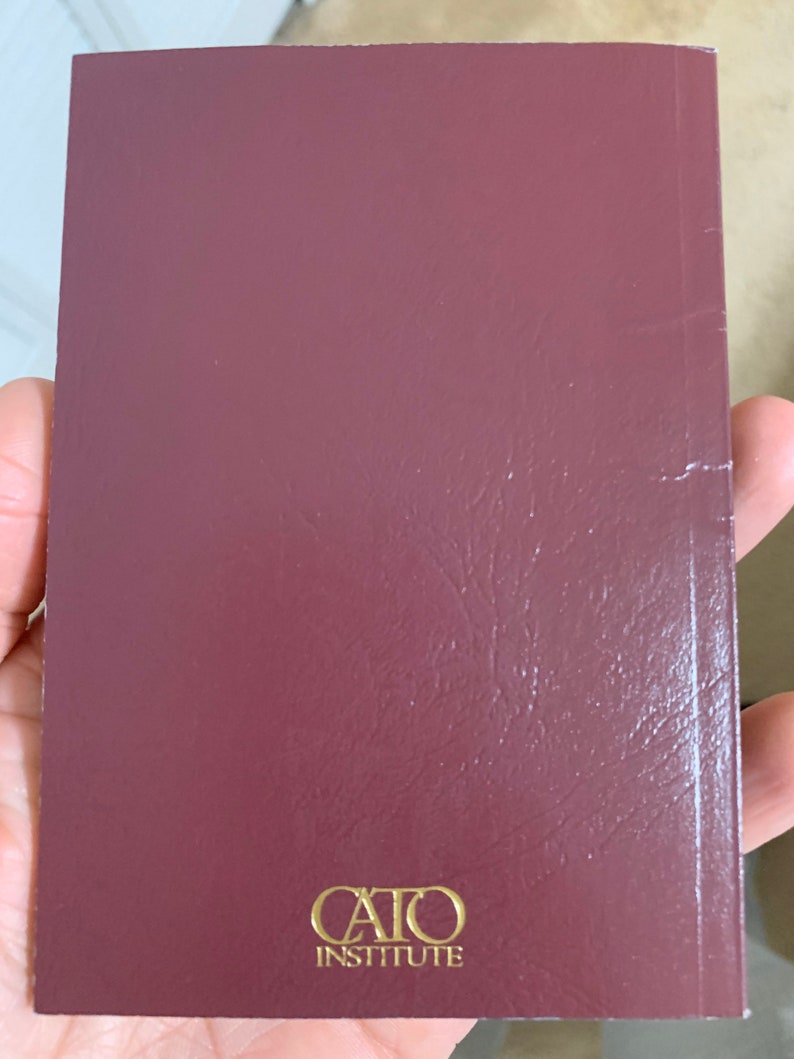 May include: A burgundy-colored book with the text "CAIO INSTITUTE" printed in gold on the cover.