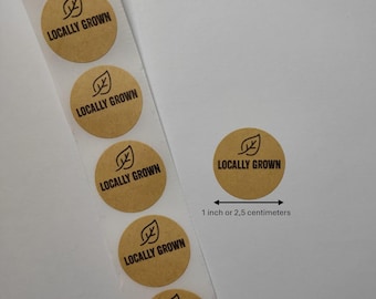 May include: Roll of brown paper stickers with a green leaf and the text "LOCALLY GROWN" printed in black. Each sticker is 1 inch or 2.5 centimeters in diameter.