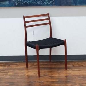 Single teak J.L. Moller 78 dining chairs with black danish cord
