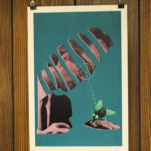 May include: A print featuring a surrealist design with a teal background. The artwork includes a segmented hand, a fly, and a dotted line. The fly is green and black, and the hand is pink and black.
