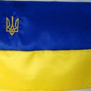 Ukrainian national flag made of crepe satin with an embroidered small gold trident. A souvenir gift to a patriot of Ukraine