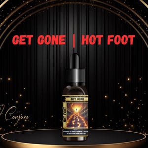 May include: A black glass bottle with a gold label that says "Get Gone | Hot Foot". The label features a fiery path with footprints and a person walking towards a bright light. The bottle is on a black and gold platform.