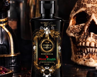 May include: A black plastic bottle of Ethereal Essence Blessed Body Oil with a black cap. The label features gold filigree, white floral accents, and text reading World of Conjure, Ethereal Essence, Blood Wealth, Extreme Prosperity, and 3.4 oz.
