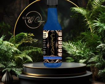 May include: A blue bottle with a gold label that says "Cleanse & Clear Wash" and "Luxury Floor Wash". The bottle is on a black and gold platform.