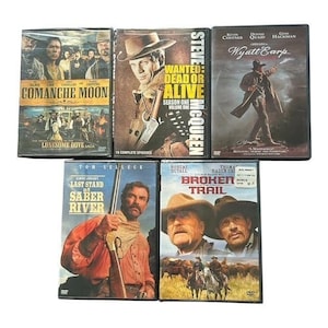 May include: A collection of five Western-themed DVD cases featuring titles including Comanche Moon, Wanted: Dead or Alive, Wyatt Earp, Last Stand at Saber River, and Broken Trail. Each case displays cover art with actors in period clothing.
