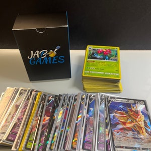 May include: A stack of Pokemon trading cards featuring a variety of characters, including Zamazenta V, with a black box labelled "JAC GAMES" in the background.