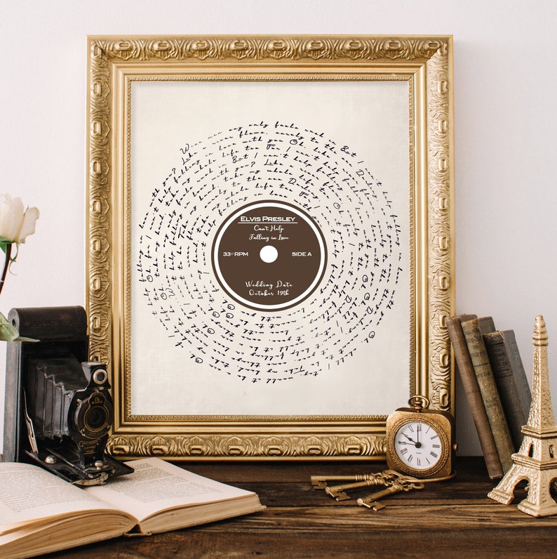 May include: A framed print of a vintage record with a handwritten lyric design. The record label features the text "Elvis Presley, Can't Help Falling in Love, 33 RPM, Side A, Wedding Date October 1958".