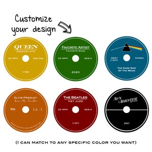 May include: Six different vinyl record designs with various artists and album titles. The designs include Queen, Elvis Presley, The Beatles, Pink Floyd, Amy Winehouse, and a generic "Favorite Artist" design. Each design features the artist's name, album title, and year of release.