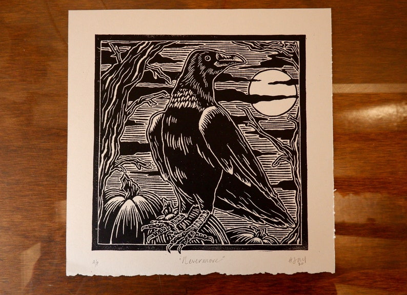 May include: Black and white woodcut print of a raven perched on a pumpkin with a full moon in the background. The print is signed "Livermore" and numbered 4/30.
