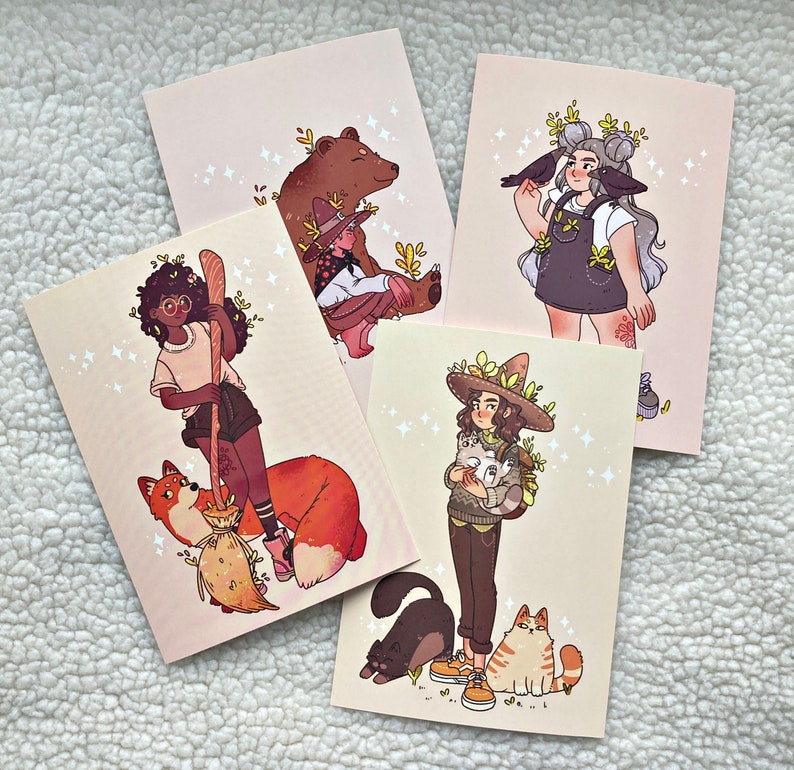May include: Four illustrated cards featuring different characters and animals. The first card shows a brown bear with a witch wearing a green hat and holding a staff. The second card shows a woman with brown hair wearing a green dress and holding a broom. The third card shows a woman with brown hair wearing a green dress and holding a broom. The fourth card shows a woman with brown hair wearing a green dress and holding a broom.