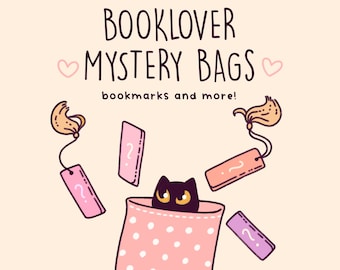 May include: A pink polka dot bag with a black cat peeking out of the top. The bag is filled with pink and purple bookmarks with question marks on them. The text "BOOKLOVER MYSTERY BAGS bookmarks and more!" is at the top of the image.