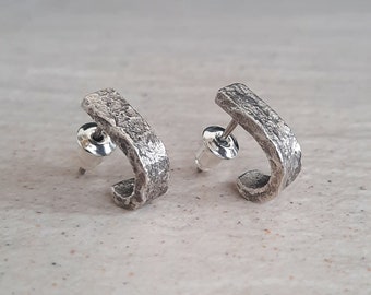 Silver stud earrings for men and women.