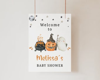 May include: A white rectangular sign featuring the text Welcome to Melissa's BABY SHOWER. The design includes a black cauldron with orange liquid, an orange jack-o'-lantern wearing a witch hat, a white ghost, and black stars and a moon.