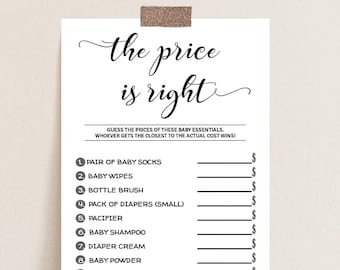 May include: A white paper game sheet for a baby shower, titled "the price is right." The game lists baby essentials like socks, wipes, and diapers, with lines for guests to guess prices. A decorative, textured, brown clip holds the paper.