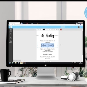 May include: A computer monitor displays a baby shower invitation template. The invitation reads "oh baby" in elegant script, with details including the honoree's name, date, time, and location. The screen also shows editing tools.
