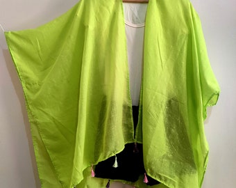 May include: A lime green sheer kimono with colorful tassels hanging from the hem.