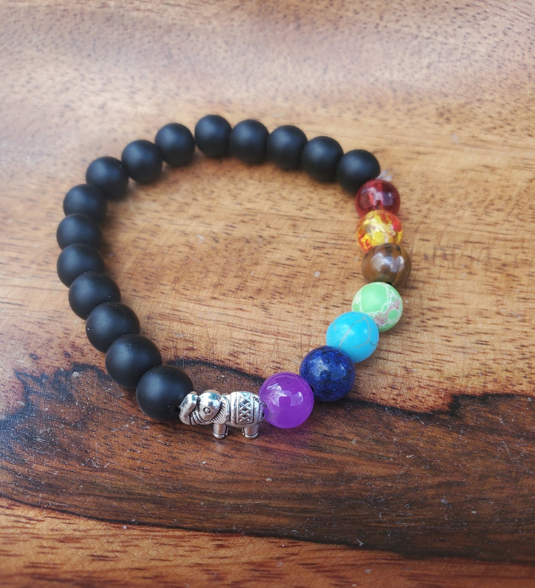 Stretch Cord Bracelet With Black and Multicolor Beads and an Elephant