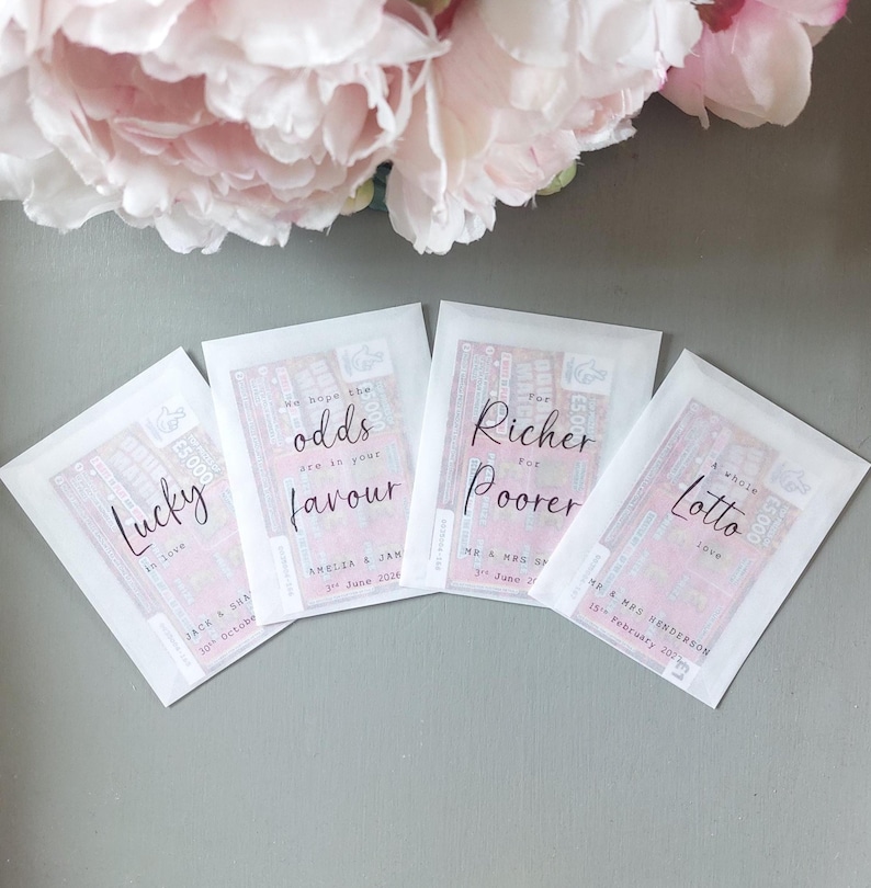 May include: Four rectangular white envelopes containing lottery tickets, each with black printed text. The envelopes feature phrases like Lucky in love, We hope the odds are in your favour, For Richer For Poorer, and a whole lotto love with names and dates.