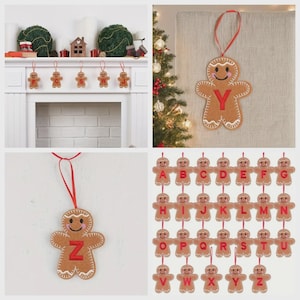 May include: A collection of brown felt gingerbread man ornaments, each featuring a red embroidered letter of the alphabet from A to Z. The ornaments have white stitched details, pink cheeks, and a red ribbon loop for hanging on a tree or mantel.