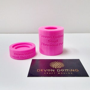 May include: Two pink silicone molds for making small threaded pots. The molds are labeled "Devon Dotting Small Threaded Pot".