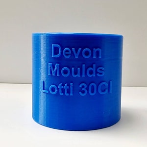 May include: A blue plastic mould for making candles, labelled "Devon Moulds Lotti 30cl".