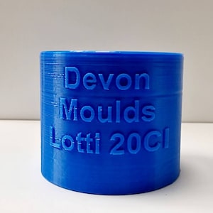 May include: A blue plastic mold for making candles, labeled "Devon Moulds Lotti 20cl".