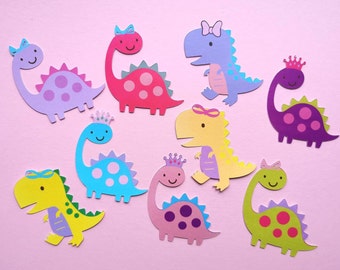 May include: Nine colorful paper dinosaur cutouts with various patterns and colors, including purple, pink, blue, yellow, and green. Each dinosaur has a crown or bow on its head.