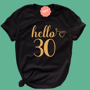 May include: Black t-shirt with gold lettering that says "hello 30" with a small heart.