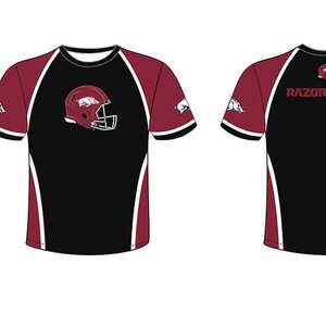 May include: Black and maroon short-sleeved t-shirt with a white trim. The front of the shirt features a white and red helmet with a pig logo. The back of the shirt has the word "RAZORBACKS" in white letters.