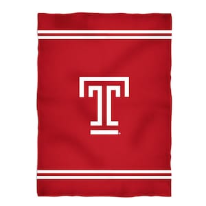 May include: Red fleece blanket with a white Temple University logo and two white stripes at the top and bottom.