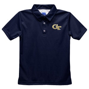 May include: Navy blue polo shirt with short sleeves and a collared neckline. The shirt features a gold "GT" logo on the left chest. The shirt has three buttons at the placket. The fabric appears to be a lightweight, breathable material.