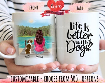 May include: White ceramic mug with a personalized illustration of a woman and a dog on a dock, with the text "Life Is better with Dogs" on the back. The front of the mug has the names "Dexter" and "Melissa".