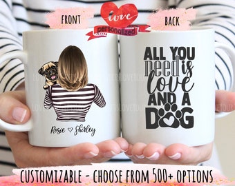 May include: White ceramic mug with a black and white illustration of a woman with a pug dog on her shoulder. The text "Rosie Shirley" is printed on the front of the mug. The back of the mug has the text "All you need is love and a dog" with a paw print graphic.