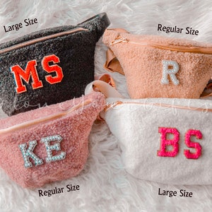 May include: Four fuzzy fanny packs in different colors with personalized initials. The packs are available in two sizes: large and regular. The initials are in different colors and styles.