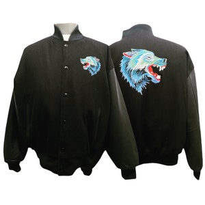 May include: Black varsity jacket with a blue and red wolf embroidered on the back and a smaller wolf embroidered on the left chest.