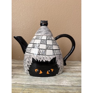 May include: A set of three ceramic mugs with a speckled, matte finish. The mugs are in shades of cream, light gray, and dark gray. Each mug has a simple, minimalist design, perfect for coffee or tea.