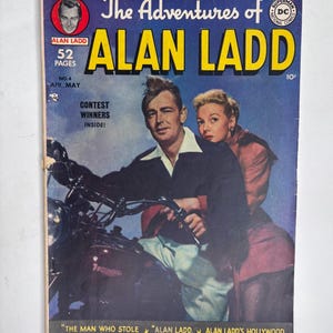 May include: A vintage comic book titled The Adventures of Alan Ladd, No. 4, featuring a man and woman on a motorcycle. The cover displays the text 52 Pages, Contest Winners Inside, and story titles including The Man Who Stole Alan Ladd's Identity.