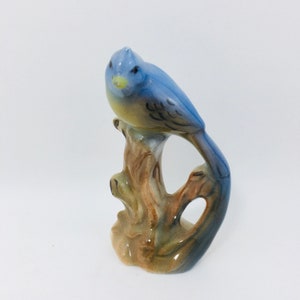 Blue Jay Bird Figurine Sitting On A Tree Stump