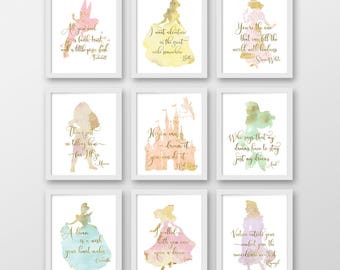 May include: Nine watercolor prints featuring silhouettes of Disney princesses with inspirational quotes in gold lettering. The prints are framed in white frames and have a light pink, yellow, and blue background.