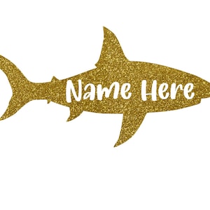 May include: Gold glitter shark silhouette with the text "Name Here" in white.