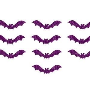 May include: Ten purple glitter bats with a pointed wing shape. The bats are arranged in three rows with three bats in each row and one bat in the bottom row.