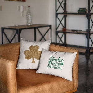 st patricks day sayingsapplied to white pillows onsitting on a brown chair