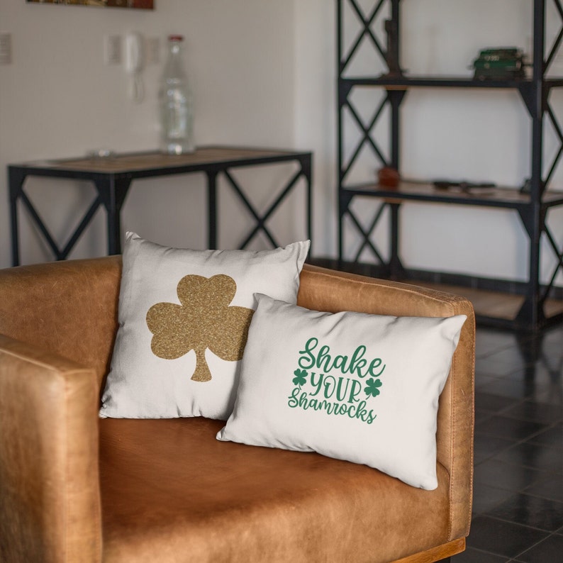 st patricks day sayingsapplied to white pillows onsitting on a brown chair