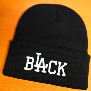 May include: Black beanie with a white "L.A. BLACK" embroidered design.