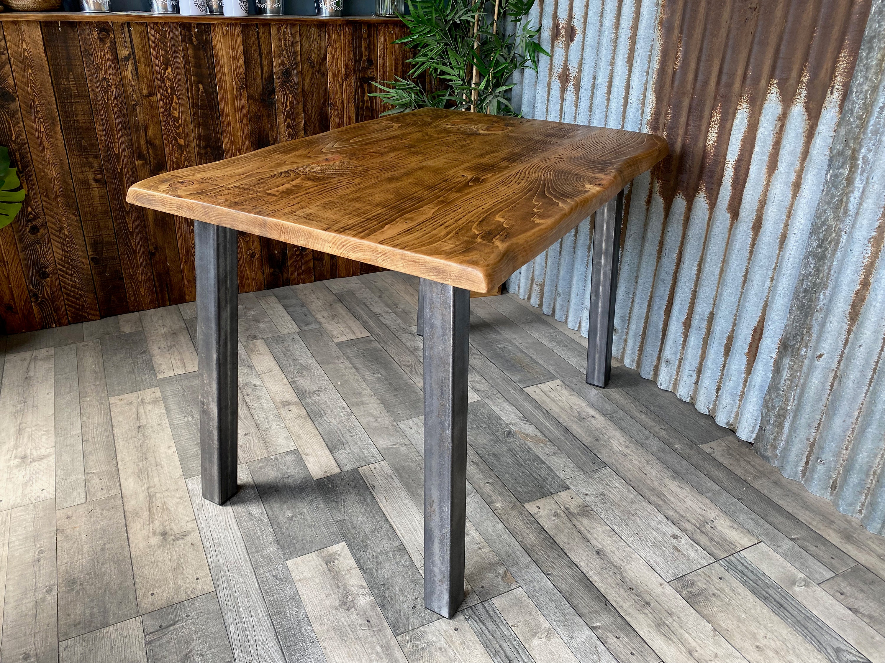 Live edge dining table with angled steel legs, Waney edge rustic