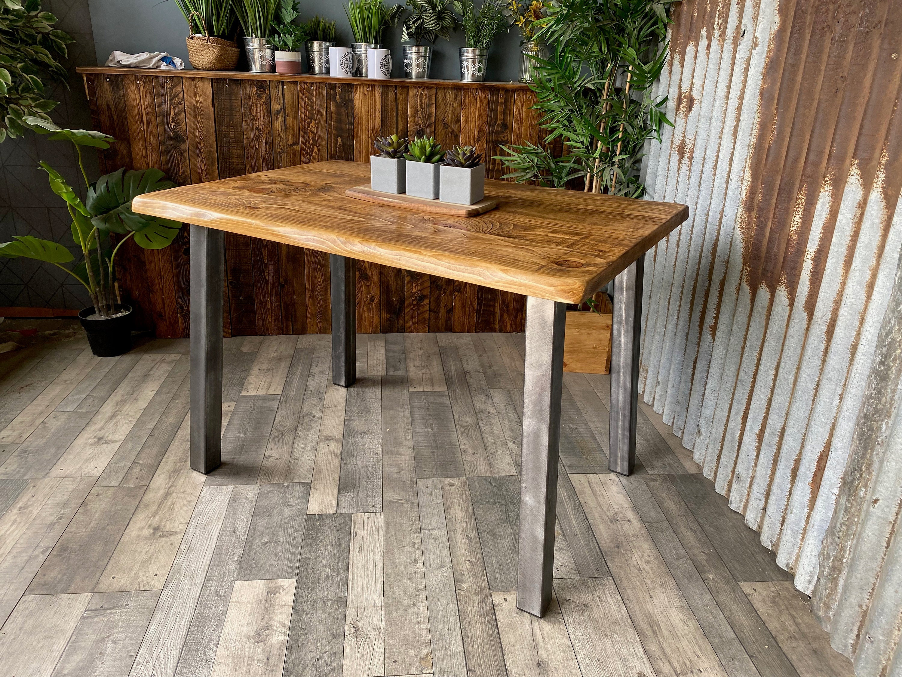 Live edge dining table with angled steel legs Waney edge rustic