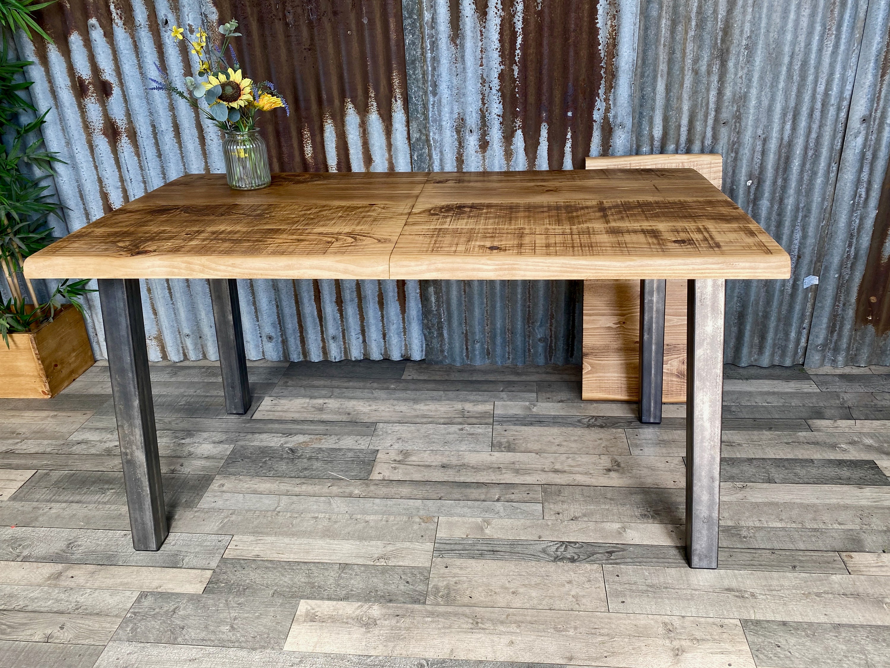Live Edge extending dining table with angled steel legs, waney edge
